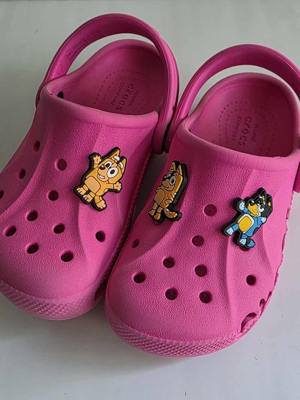 CROCS Kids Bright Pink Clog Sandals with Bluey Charms.